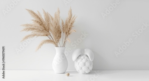 Minimalist white home decor styled with natural dried rabbit tail floral element