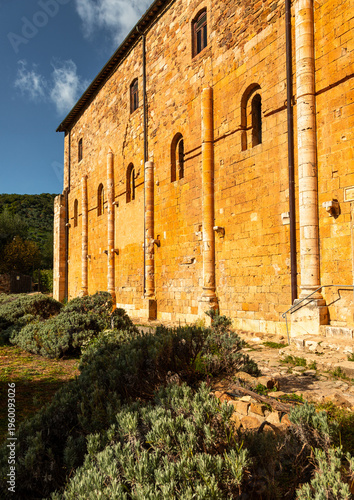 Картината върху платно Abbazia di Sant'Antimo wall with Romanesque architecture in Tuscany, Italy