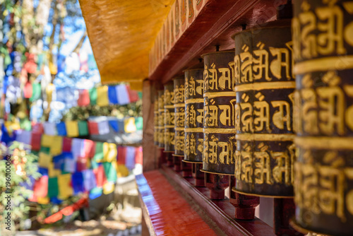 фотографія buddhist prayer wheels in temple