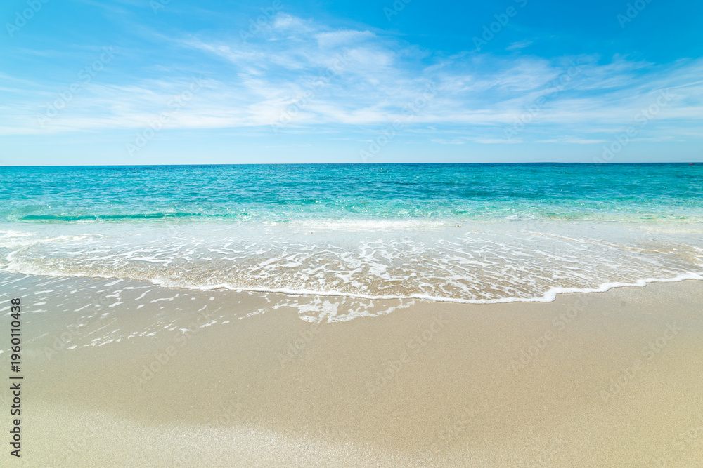Fototapeta premium Beach with turquoise water and white sand under a blue sky in Sardinia
