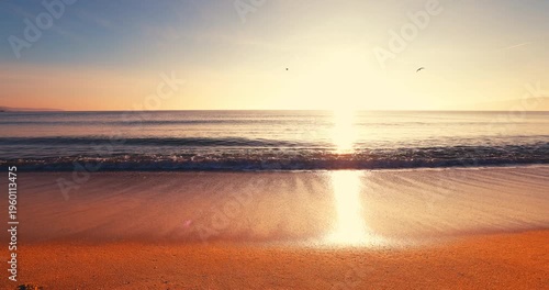 Golden ocean sunrise over tropical beach shore and rolling sea waves on the sand with soft sunlight summer vacation concept cinematic video