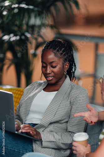 Young black woman collaborating using computer laptop