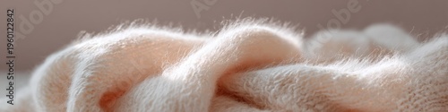 Creamy soft wool blanket close up folded fabric texture warm cozy neutral beige tones macro home textile detail for styling and interior comfort