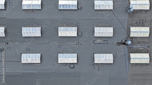Roof windows in an office building and shopping center allow natural sunlight to penetrate. Natural lighting in an industrial facility is provided through roof windows in a workshop.