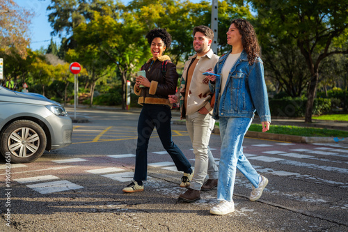 Cuadro en lienzo Diverse group of young adult friends walking together and smiling across a pedes