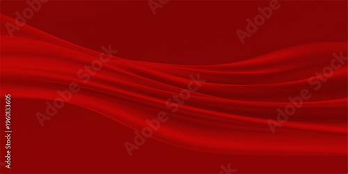 Flowing elegance: a close-up of luxurious crimson fabric, gracefully draped and softly illuminated, offering a mesmerizing display of texture and color.