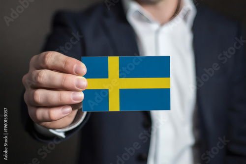Sophisticated professional displaying Swedish flag, showcasing patriotism, global connections, and international business ventures