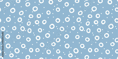 Seamless pattern with decorative circles and dots in soft blue pastel tones. Perfect for textile, wrapping paper, wallpaper and background design.