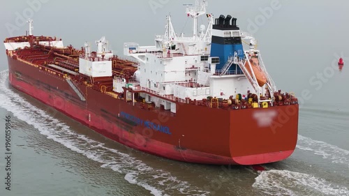 stern section red tanker white superstructure blue and black funnel orange lifeboat complex up close drone view oil fuel gas crisis sea gulf qatar iran war 