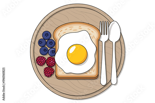 Fried egg on toast with blueberries and raspberries on wooden plate with cutlery
