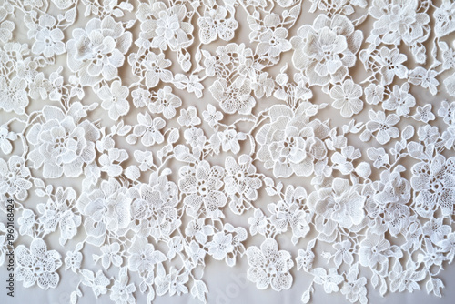 Large, layered floral blossoms are linked by delicate thread bridges in this creamy ivory guipure lace, creating a dimensional, sculptural texture with an elegant and timeless aesthetic