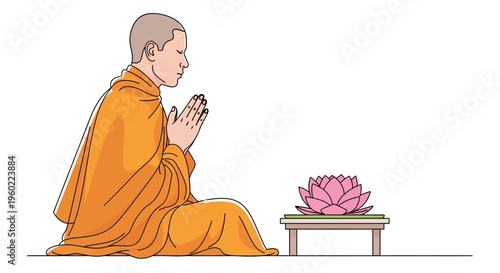 Buddhist monk in orange robes praying.