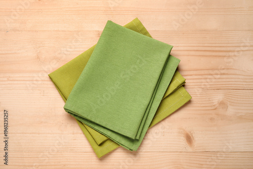 Green napkins on wooden bac...