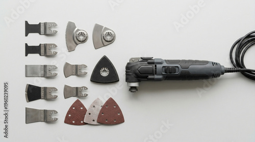 Corded oscillating multi-tool with various sanding and cutting attachments, home renovation equipment, carpentry tool set.