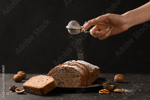 Woman sprinkling sugar powd...