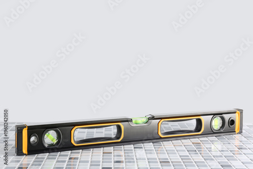 Spirit level on tiled floor...