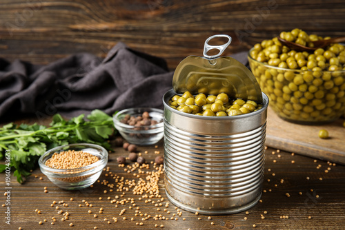 Tin can and glass bowl with...