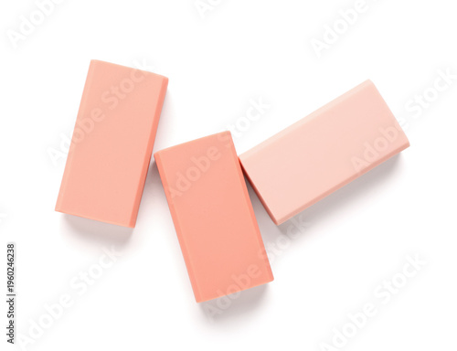 Orange rubber erasers on wh...