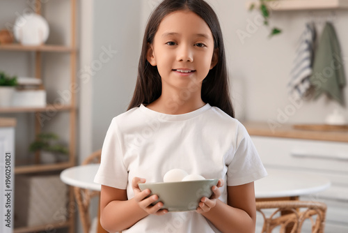 Cute Asian girl with bowl o...