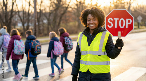 Wallpaper Mural Crossing guard holding a stop sign while children cross the street in a crosswalk Torontodigital.ca