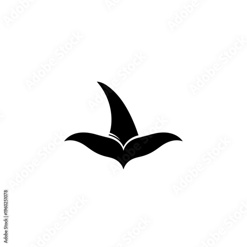 Black silhouette of a flying manta ray.