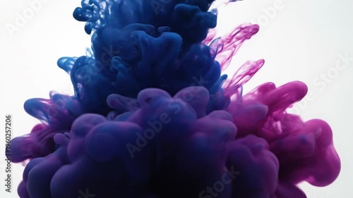 Small orbiting droplet of deep purple ink falling into clear water