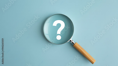 A magnifying glass focuses on a white question mark against a light blue background