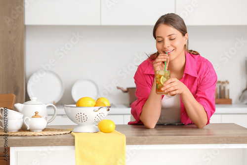Young woman with ice tea at...