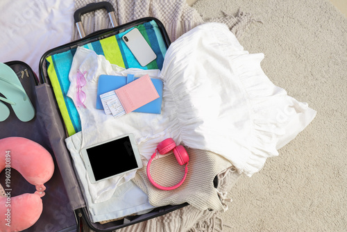 Open suitcase with headphon...
