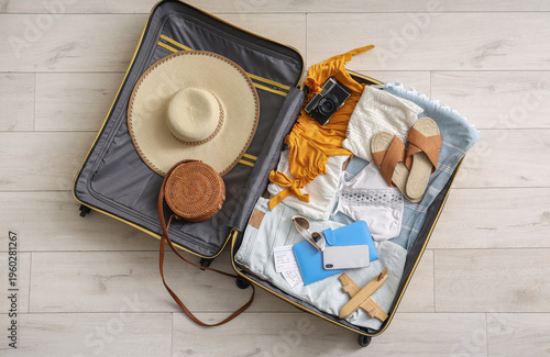 Open suitcase with clothes,...