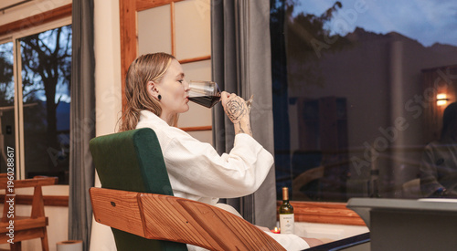 Woman tourist in white bathrobe relaxing in hotel jacuzzi