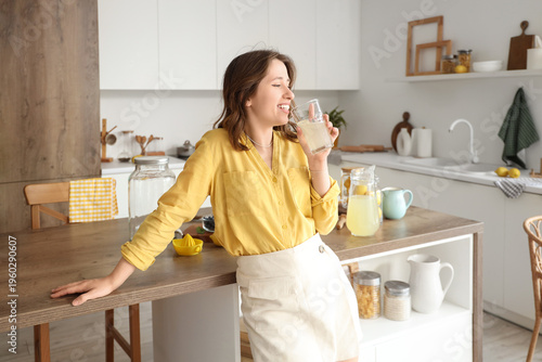 Young woman drinking fresh ...