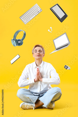Mature woman meditating on ...