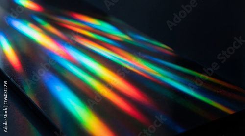 Fotografi Captivating light spectrum refraction creating vibrant rainbow beams across a dark, textured background