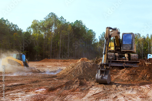 Εκτύπωση καμβά Two pieces of heavy equipment are clearing land in dirt prepare area for upcoming projects
