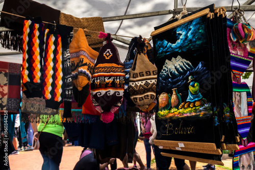 Wallpaper Mural Sao Paulo, Brazil, Dec 21, 2025. Stall in Kantuta Fair, a Bolivian street market in Sao Paulo. The scene of the cultural tradition, showcasing colorful textiles, hats, and local crafts. Torontodigital.ca