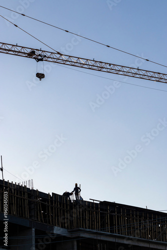 Wallpaper Mural Construction site, silhouettes of construction industry workers on scaffolding against the sunset light. Constructing and building industry in Brazil Torontodigital.ca