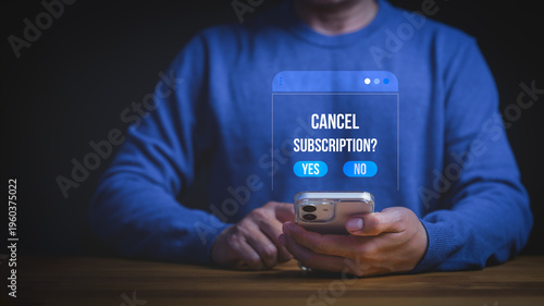 Man using smartphone to cancel subscription on digital app interface. Unsubscribe from online service membership or payment plan. Mobile technology concept for business.