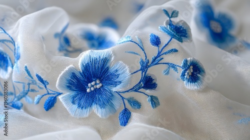 Close-up of delicate blue flowers on a soft white fabric background.