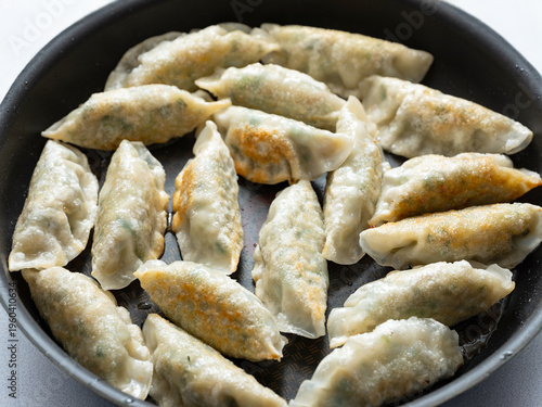 Fried dumplings in an iron pan