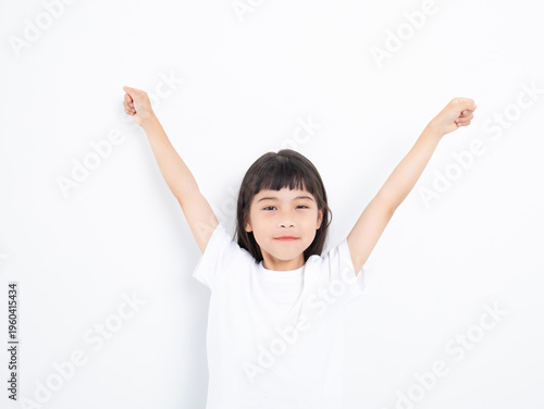 Photos A Young Chinese Girl Stretching in Front of a White Background