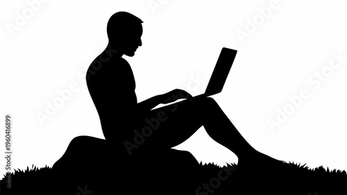 Digital nomad working on laptop sitting in grassy field with silhouette