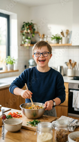 A joyful boy with Down syndrome wearing an apron stirs ingredients in a bowl in a bright kitchen, home baking moment, disability inclusion, creative hobby.