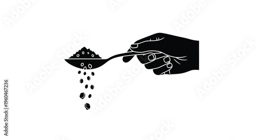 A hand holds a spoon with grains falling from it in black and white