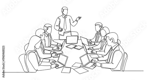 Business meeting in progress: team collaborating around a table with laptops