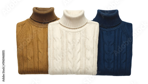 Three folded cable-knit turtlenecks, differing in color, neatly arranged against a black backdrop