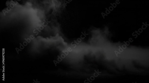 Abstract white smoke and steam swirls like a dark stormy cloudscape against a black night background