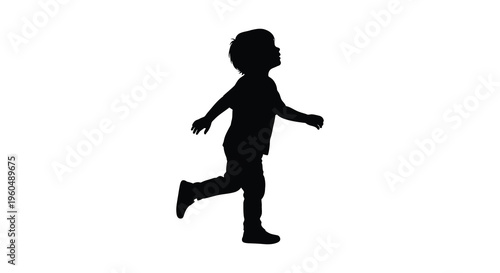 A young child is captured mid stride appearing to run or walk with outstretched arms a striking silhouette