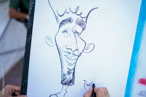 Artist drawing a humorous caricature portrait of a man with a mustache and beard