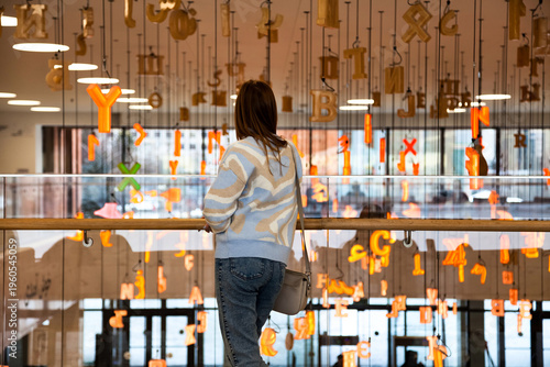 Photos A young woman gazes upon floating letters and symbols at the Kazan National Library